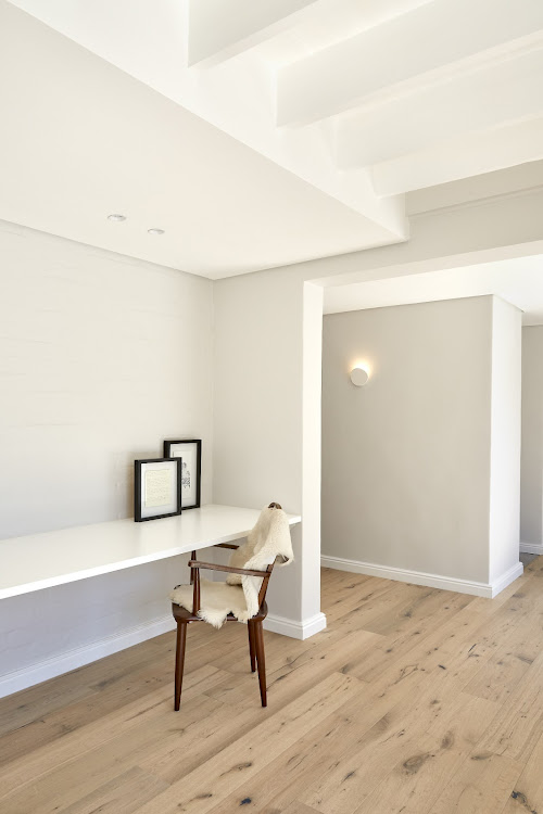 The home's original timber ceiling beams have been completely transformed with a lick of paint.