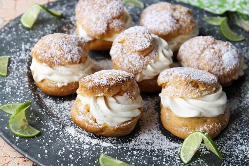 Key lime cream puffs dusted with powdered sugar.