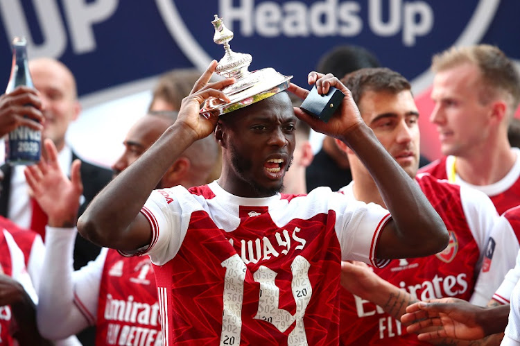 Nicolas Pepe of Arsenal celebrates with the lid of the Heads Up Emirates FA Cup Trophy following his team's victory in the FA Cup Final match between Arsenal and Chelsea at Wembley Stadium on August 01, 2020 in London, England.