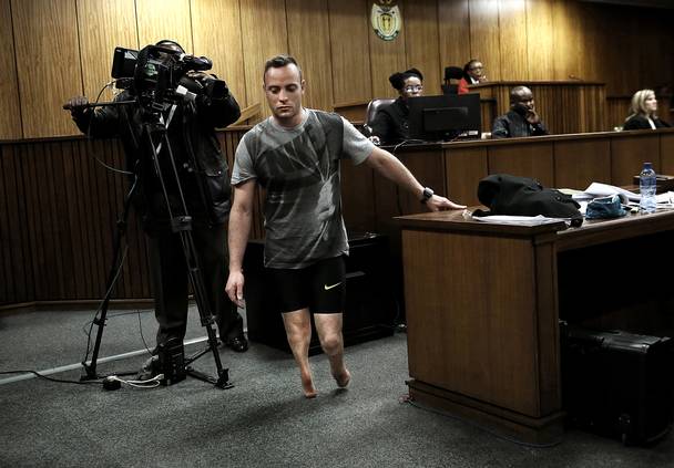 Oscar Pistorius stands without his prosthetic limbs in front of a packed courtroom. The former lauded runner was asked by his defence counsel Barry Roux to remove his fake limbs to demonstrate how vulnerable the Paralympian was without his prosthetics. Pistorius was on his stumps when he fatally shot Reeva Steenkamp through a toilet cubicle door in his home 2013 - he testified at his murder trial that he felt vulnerable and thought an intruder was in the house. He was convicted of murder by the Supreme Court of Appeal of South Africa for killing his girlfriend, Reeva Steenkamp in 2013. Pistorius is currently serving a prison term in a prison in Prertoria, South Africa.