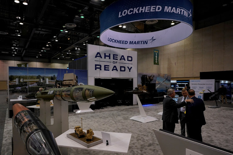 People converse in Lockheed Martin's booth during a symposium in Huntsville, Alabama, US. File photo: CHENEY ORR/REUTERS