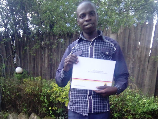 Kiptororo Ward Jubilee party nominee Kibet Kurgat posses for a picture with his nomination certificate. /AMOS KERICH