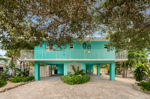 Turquoise house on stilts with balcony in this luxury property for sale in Key Largo ($975,000 - 129 m²)