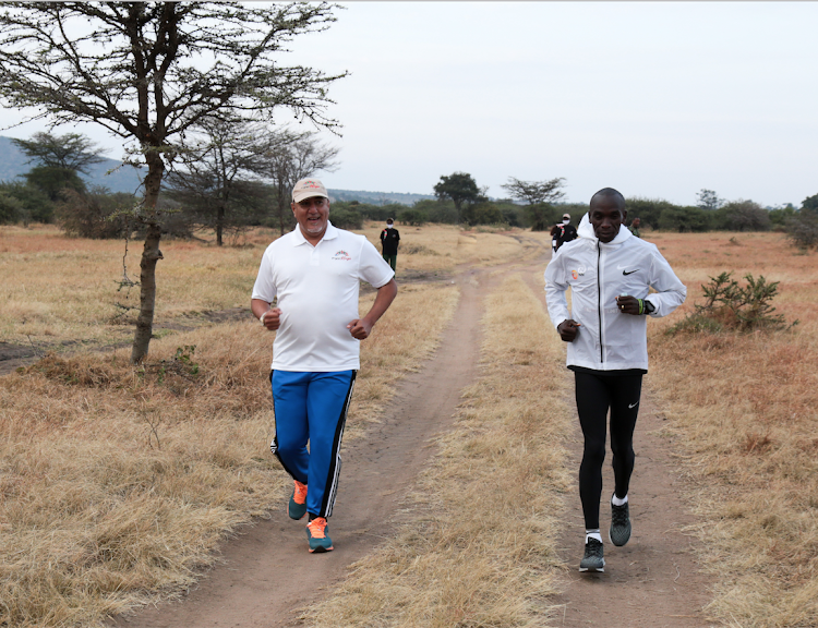 World marathon record holder Eliud Kipchoge with Tourism Cabinet Secretary Najib Baala during a morning run at the Maasai Mara Game Reserve on Sunday