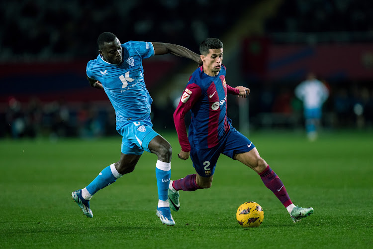 Barcelona Joao Cancelo (R) dribbles past Dion Lopy of Almeria