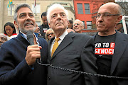 Clooney with his father Nick, centre, and activist Tom Andrews at a protest outside the Sudanese Embassy  in Washington DC in 2012. 