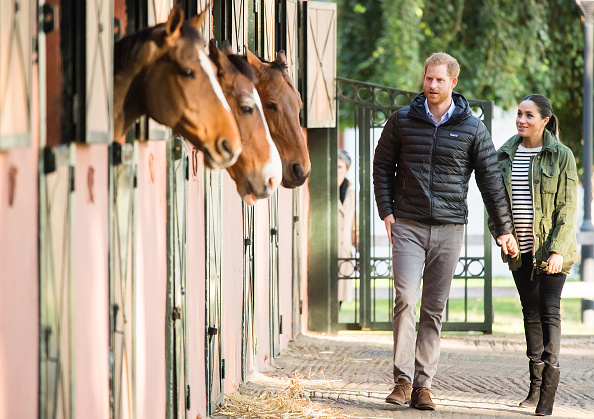 Prince Harry and Meghan, Duchess of Sussex, hold hands as they visit the Moroccan Royal Federation of Equestrian Sports in Rabat.