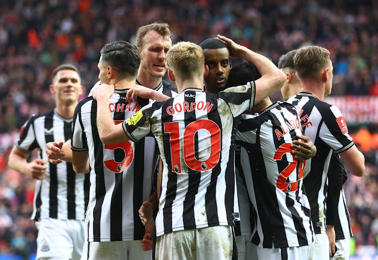 Newcastle United's Alexander Isak celebrates scoring their third goal with teammates.