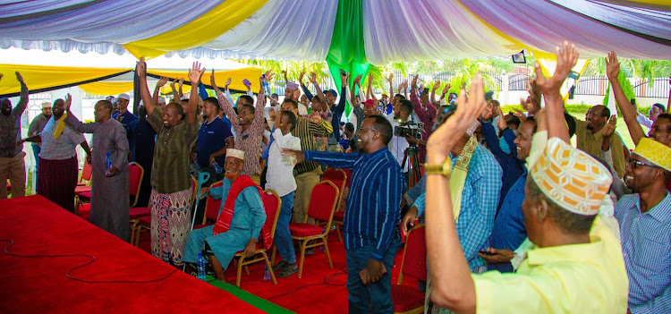 The Balweynta Hawiye community members raise their hands in support for Garissa Township MP Aden Duale's re-election bid at his residence on Tuesday, June 21.