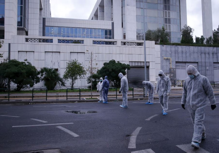 Police officers search for evidence after a bomb blast at a court building in Athens, Greece, December 22, 2017.