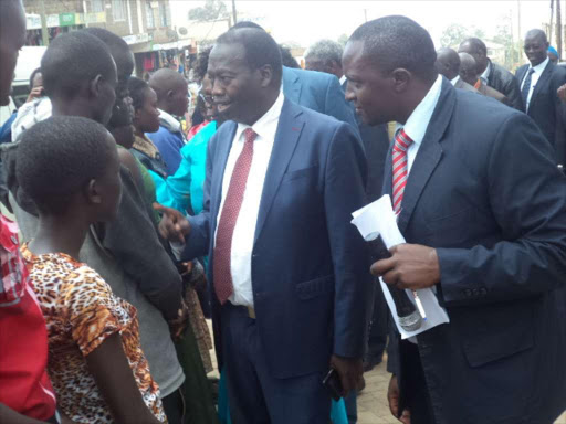 Baringo County Governor Benjamin Cheboi (Centre) with Equity bank branch manager David Mwangi while presenting cheques to the beneficiaries in Kabarnet town on Wednesday. Cheboi urged pokot community to stop circumcising boys and take their children to school. PHOTO/JOSEPH KANGOGO