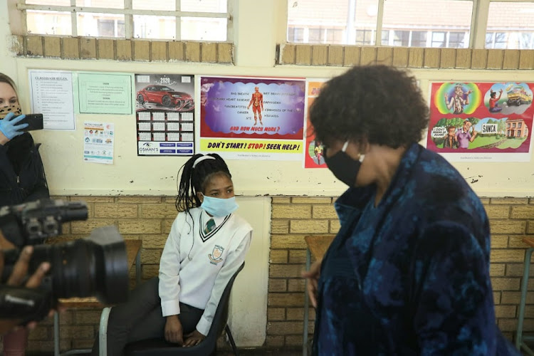 Grade 12 pupils at Phulong Secondary School in KwaThema with basic education minister Angie Motshekga. Some pupils said they feel safer at school because they are reminded to wear masks and to sanitise regularly. File image