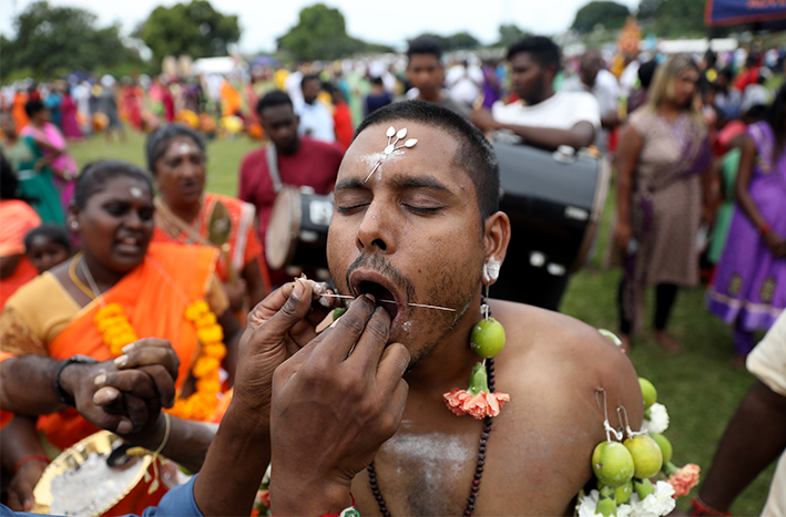 Hindus show their devotion to the Hindu god Murugan by piercing their bodies.