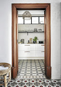 A local carpenter made the deep white storage drawers in the compact kitchen. 