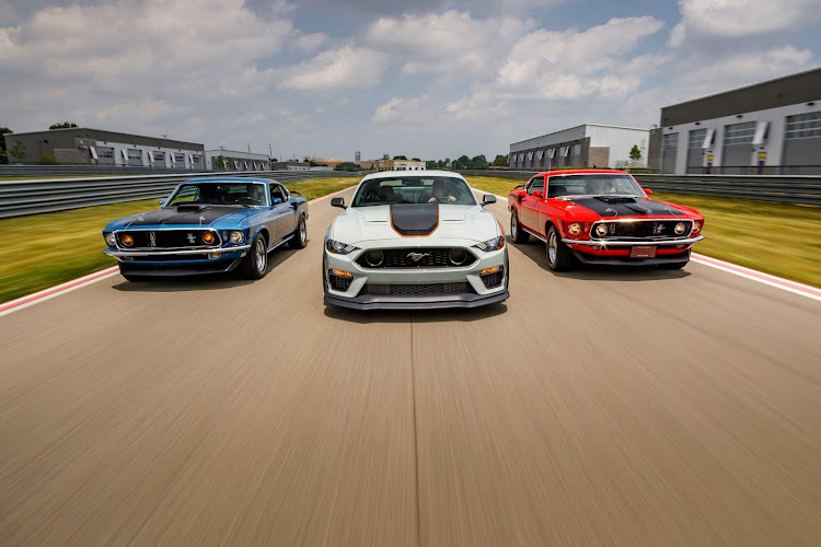 The new 2021 Ford Mustang Mach 1 flanked by its predecessors.