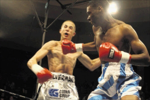 FIRING ON ALL CYLINDERS: Oupa Maimane throws a straight right at Jared Silverman during their lightweight bout at the Nasrec Indoor Arena in Soweto. Maimane won the fight by a majority points decision. Pic: BAFANA MAHLANGU. 15/05/2010. © Sowetan.