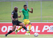 Pule Mmodi of Golden Arrows challenged by Samuel Manganyi of Royal AM during the DStv Premiership match between the two sides at Chatsworth Stadium on December 12, 2021 in Chatsworth, South Africa. 