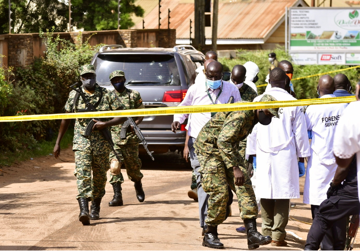 Security forces and forensic experts secure the scene of an attempted assassination on Ugandan minister of works and transport General Katumba Wamala in the suburb of Kiasasi within Kampala, Uganda on June 1 2021.