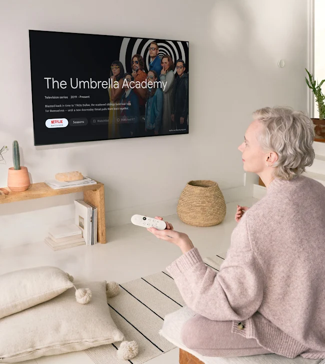 A person watches The Umbrella Academy with Chromecast with Google TV in their cozy living room