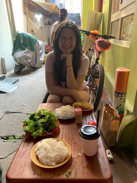 Enjoying bún chả in Hanoi.