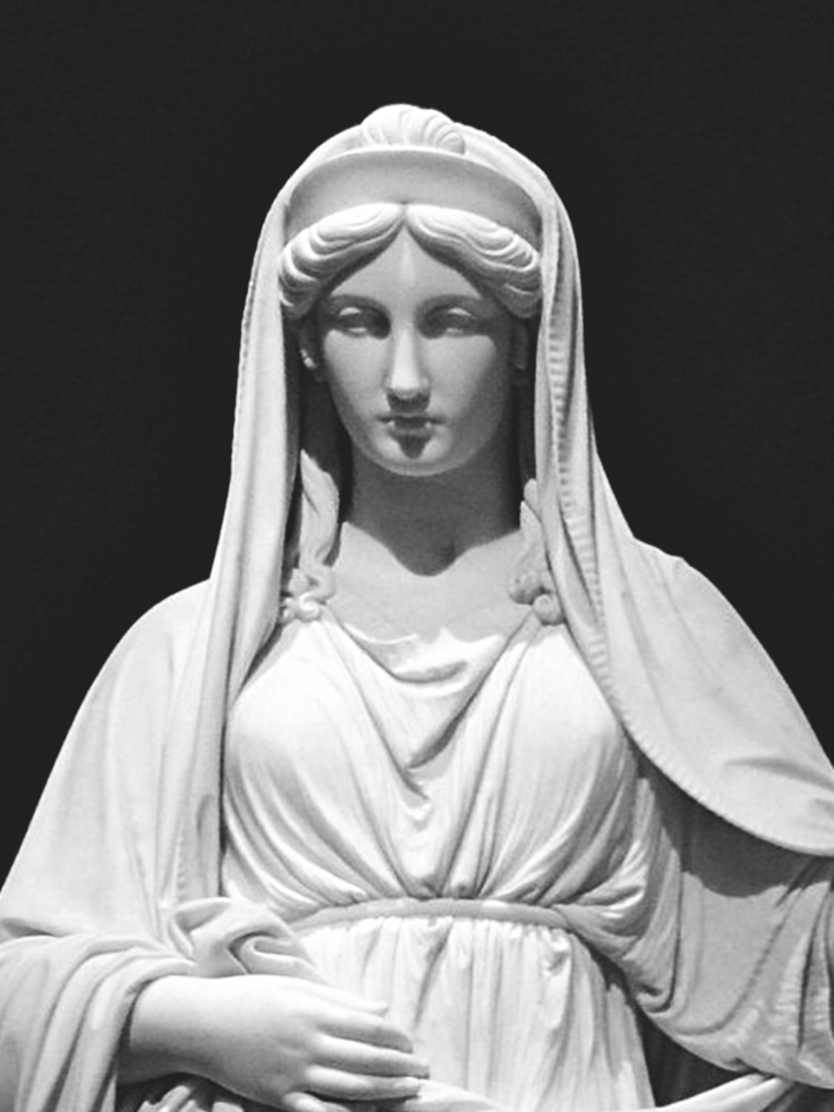 This is a statue of Vesta, dressed in white with a shawl on her head.