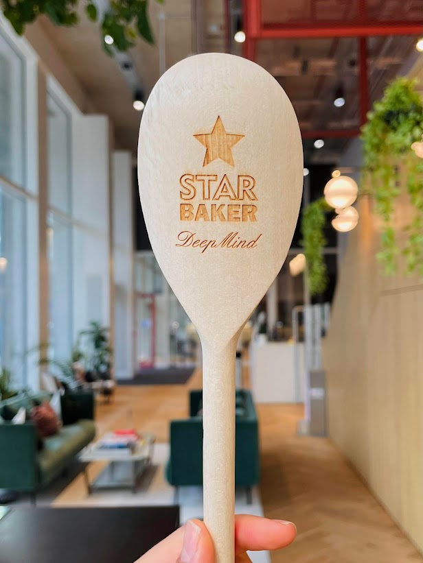 Aliya Rysbek's DeepMind Star Baker Award. The award name is carved onto a wooden spoon.