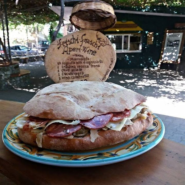 Delicious loaf of Sicilian bread filled with local salami, cheese and preserved veggies: sun-dried tomato slices, artichokes hearts, capers, eggplants etc.