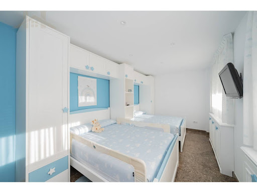 Bedroom with two blue single beds in this luxury chalet for sale in San Sebastián de los Reyes ($1,826,197 - 507 m²)