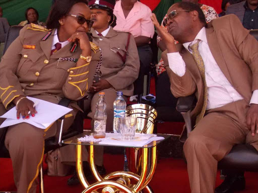 Embu County Commissioner Esther Maina chatting with Embu Governor Martin Wambora during Mashujaa Day Cerebration on December 12 2017 at Moi stadium Embu