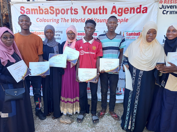 A section of youth holds business training certificate at the Samba Sports Youth Agenda office in Matuga subcounty on Thursday, August 24, 2023.