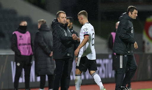 Hans-Dieter Flick, Head Coach of Germany congratulates Joshua Kimmich of Germany after the 2022 FIFA World Cup Qualifier match between Iceland and Germany at Laugardalsvollur National Stadium on September 08, 2021 in Reykjavik, Iceland.