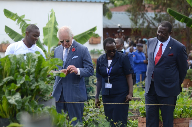 City Shamba manager Greg Kimani with King Charles III and Prime Cabinet Secretary Musalia Mudavadi during a tour of the urban farming project at Mama Lucy Kibaki Hospital on October 31, 2023.