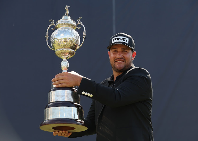 Thriston Lawrence of South Africa holds the winners trophy during Day Four of the Investec South African Open Championship at Blair Atholl Golf & Equestrian Estate on December 4 2022 in Johannesburg, South Africa. Picture: GETTY IMAGES/LUKE WALKER