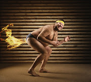 Very strange naked man farts by fire - Stock image