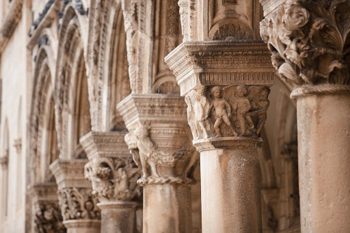 Columns line a historic building in Old Dubrovnik. 