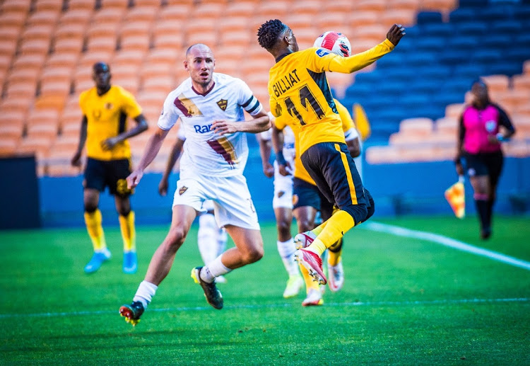 Kaizer Chiefs' Khama Billiat controls the ball while Alan Robertson of Stellenbosch FC watches in the DStv Premiership match at FNB Stadium on November 2 2021.