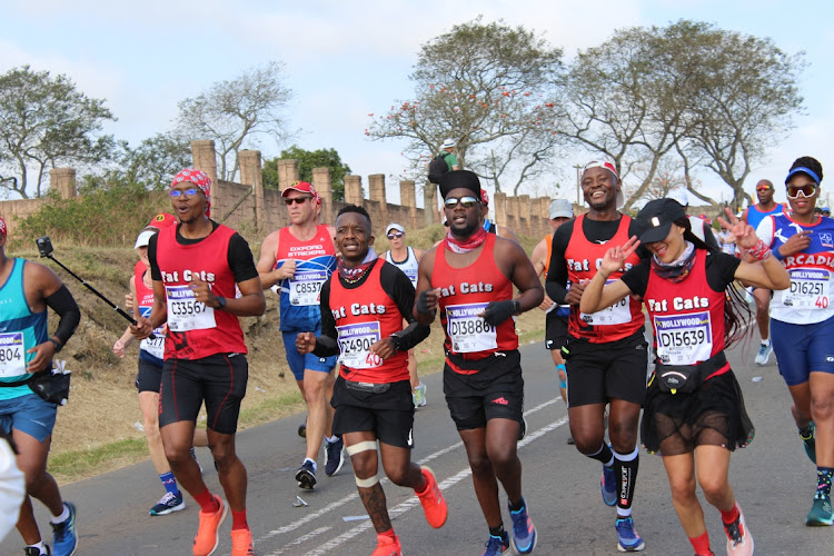 Thulani Mbele with his club mates from Fat Cats running towards Inchanga on their way to Durban from Pietermaritzburg during the Comrades Marathon.