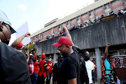 EFF leader Julius Malema greets supporters after visiting a voting station in Umlazi, KwaZulu-Natal, on September 18 2021.