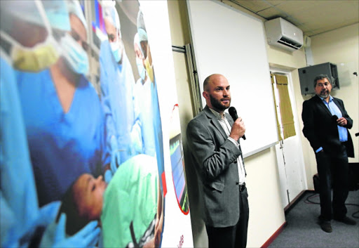 Dr Tim Pennel, left, and heart transplant recipient Raymond Hartle at a seminar at Life St Dominics Picture: MICHAEL PINYANA