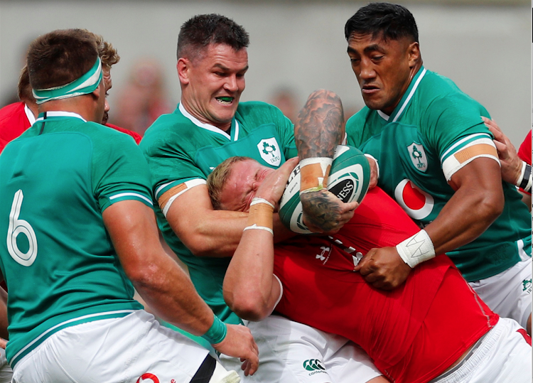 Wales' Ross Moriarty in action with Ireland's Johnny Sexton and Bundee Aki