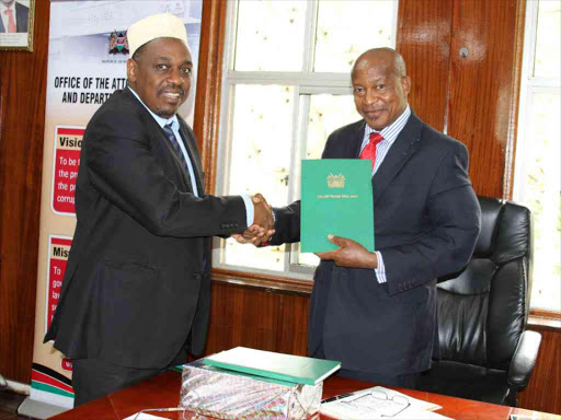 Professor Hamadi Boga handed Wakf Bill, 2018 and Taskforce on the Review of the Wakf Commissioners Act, 1951 to Attorney General Kihara Kariuki at his office, June 7, 2018. /COURTESY