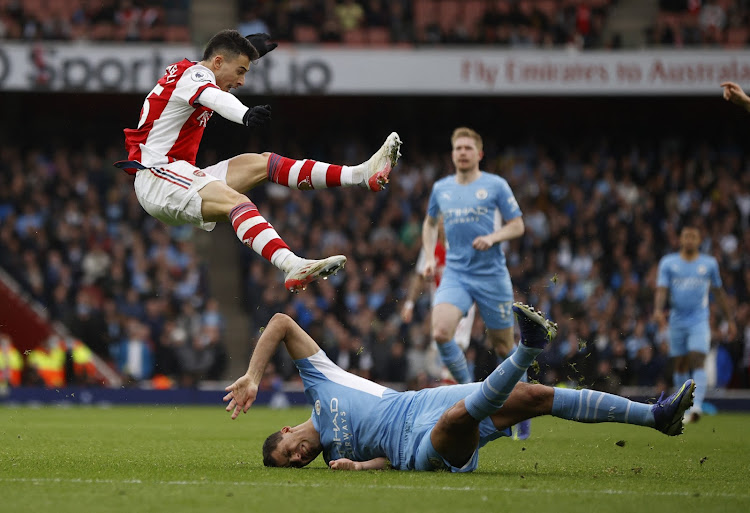 Manchester City's Rodri in action with Arsenal's Gabriel Martinelli.