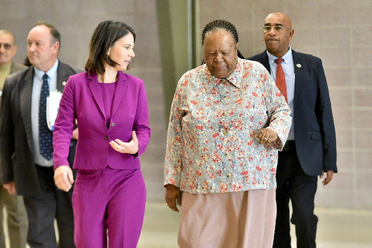 Germany's foreign minister Annalena Baerbock walks with her South African counterpart Naledi Pandor before the South Africa-Germany bi-national commission in Pretoria.