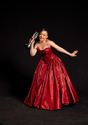 Media personality and actor Thando Thabethe holds her SAFTA award.  