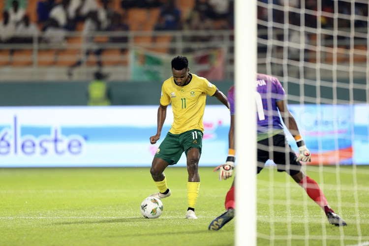 Themba Zwane of South Africa shoots and scores second goal past Lloyd Kazapua of Namibia during the 2023 Africa Cup of Nations Finals match between South Africa and Namibia at Amadou Gon Coulibaly Stadium in Korhogo on Sunday