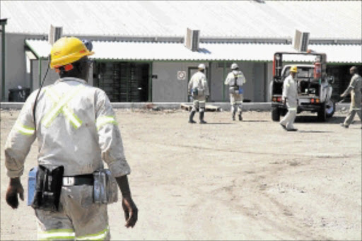 STALEMATE: Miners walk about during a visit by members of the parliamentry portfolio committee to Modikwa Platinum Mine yesterday. photo: ELIJAR MUSHIANA