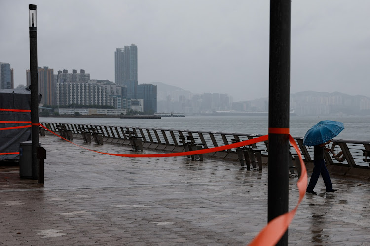 A man braves winds as Super Typhoon Saola approaches in Hong Kong, China, on September 1 2023.