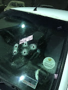 Bullet holes in the windscreen of Darren Maggott's car. 