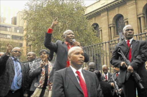 SINGING THAT SONG: ANC Youth League president Julius Malema surrounded by his bodyguards outside the Johannesburg High Court in April this year. PHOTO: MOHAU MOFOKENG