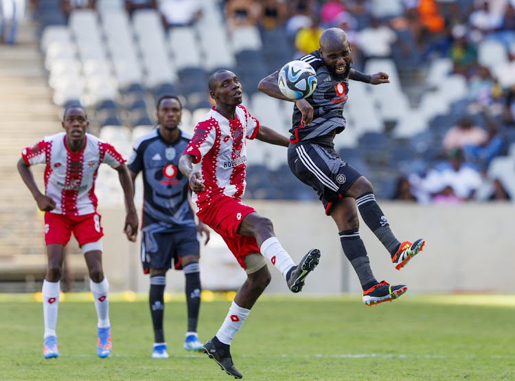 Makhehleni Makhaula of Orlando Pirates out-jumps Crystal Lake players during their Nedbank Cup last 32 match at Mbombela Stadium on Saturday.